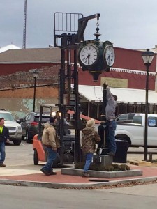 Workers and volunteers install a new clock on the Hope Town Square Thursday. Photo courtesy of Jessica Brown of Deckard Tool and Engineering.