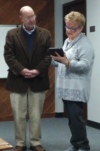 Dennis Moats receives a plaque from Martha Myers of Columbus Regional Health at a ceremony Monday at the Bartholomew County Commissioners meeting.