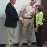 Dr. Roger Brinkman and his wife Jan Brinkman thank Dispatcher Dylan Prather at a ceremony Monday.