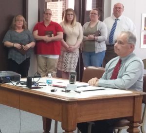 Ed Reuter, at right, recognizes Bartholomew County dispatchers at a ceremony before County Commissioners last month.