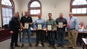 Five people received certificates from the city of North Vernon Monday for saving a life during a February traffic accident. Pictured are Chief James Webster, Dan Rennekamp, Jeff Dettmer, Nicholas Earl, James Swartz, Mayor Mike Ochs. (Joey Howard not pictured)